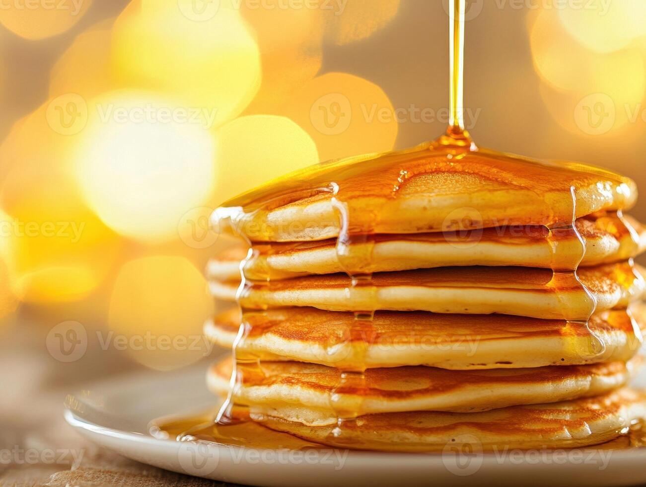Stack of fluffy pancakes drizzled with syrup on a warm morning photo