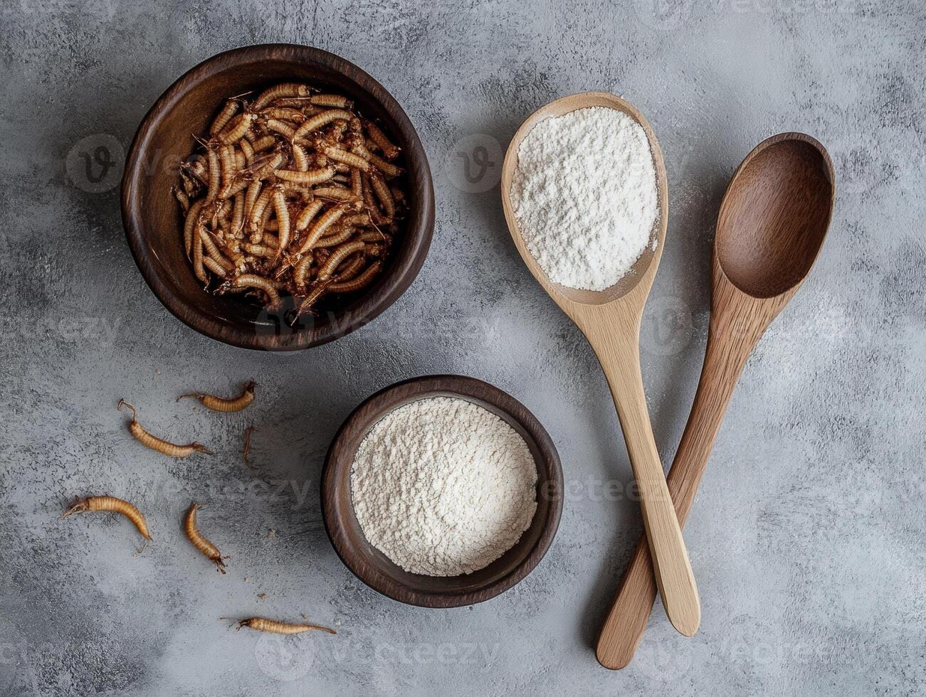 Edible insects and flour displayed on a textured surface photo
