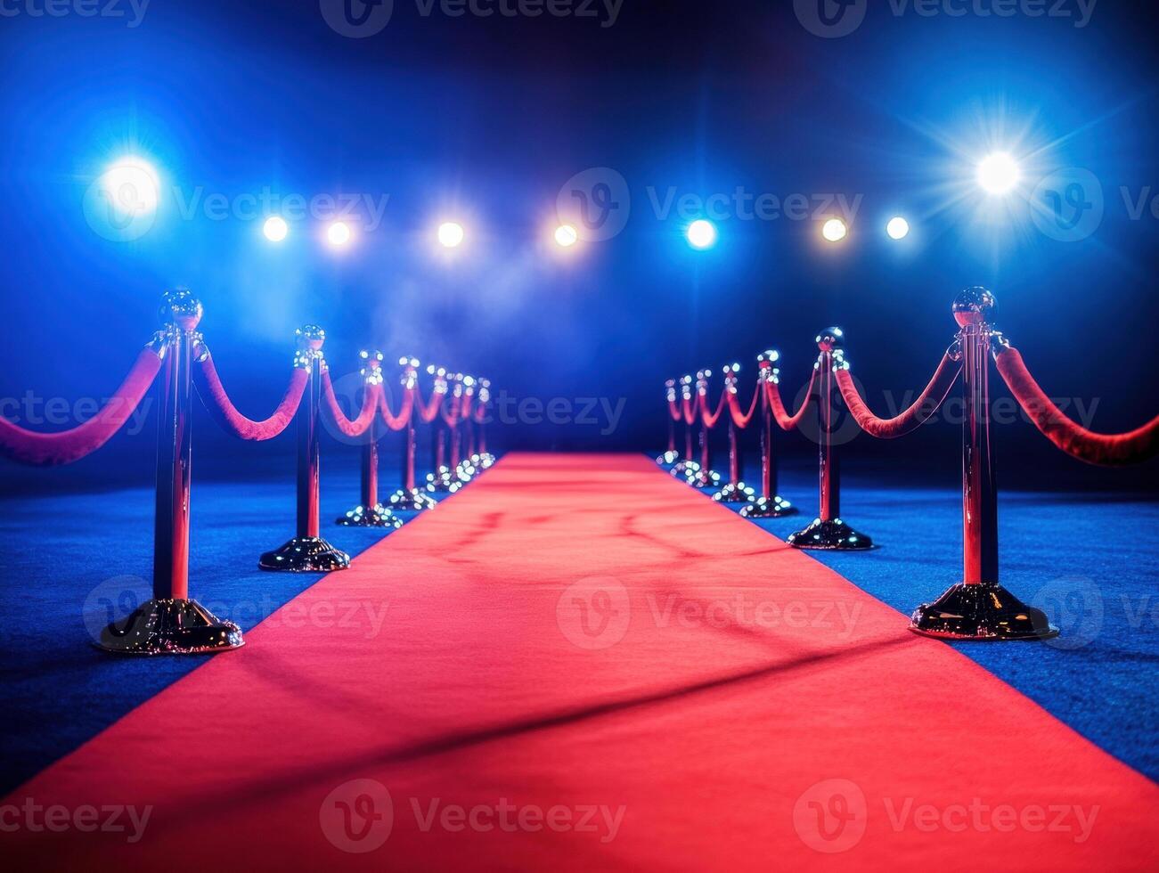 Red carpet event illuminated by vibrant spotlights in a dark venue photo