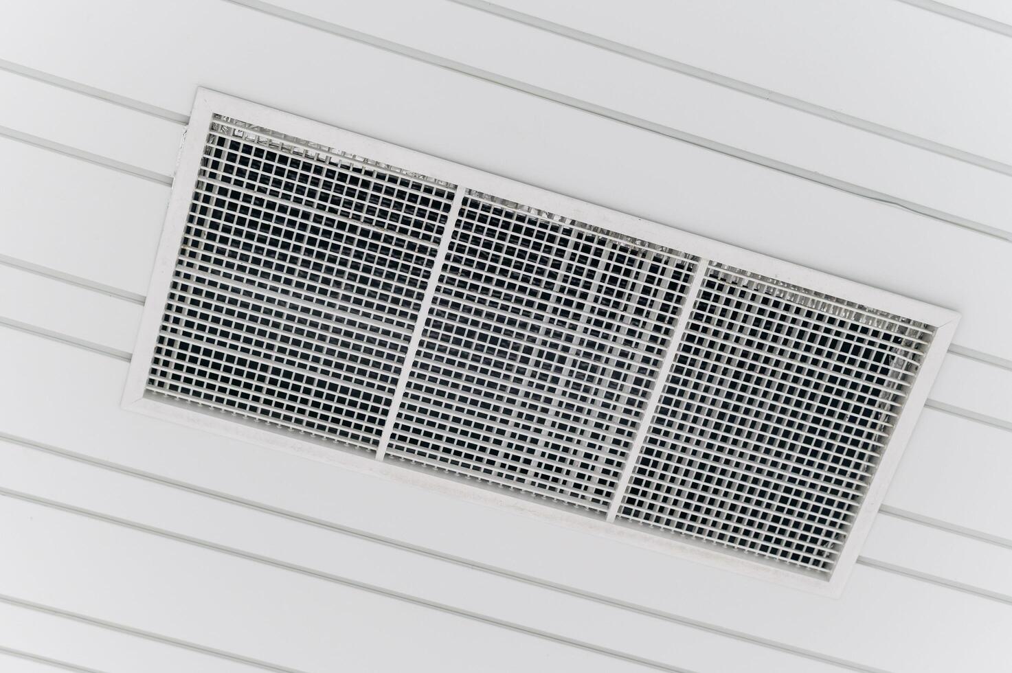 Air conditioner in a room with white walls photo