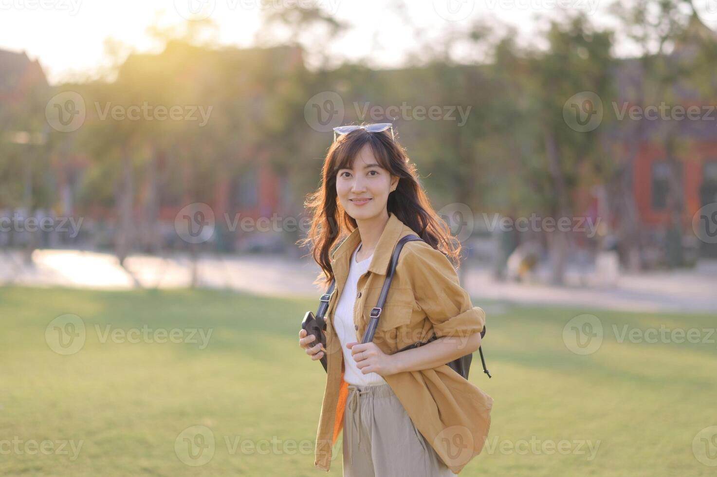 Asian woman in park with camera photo