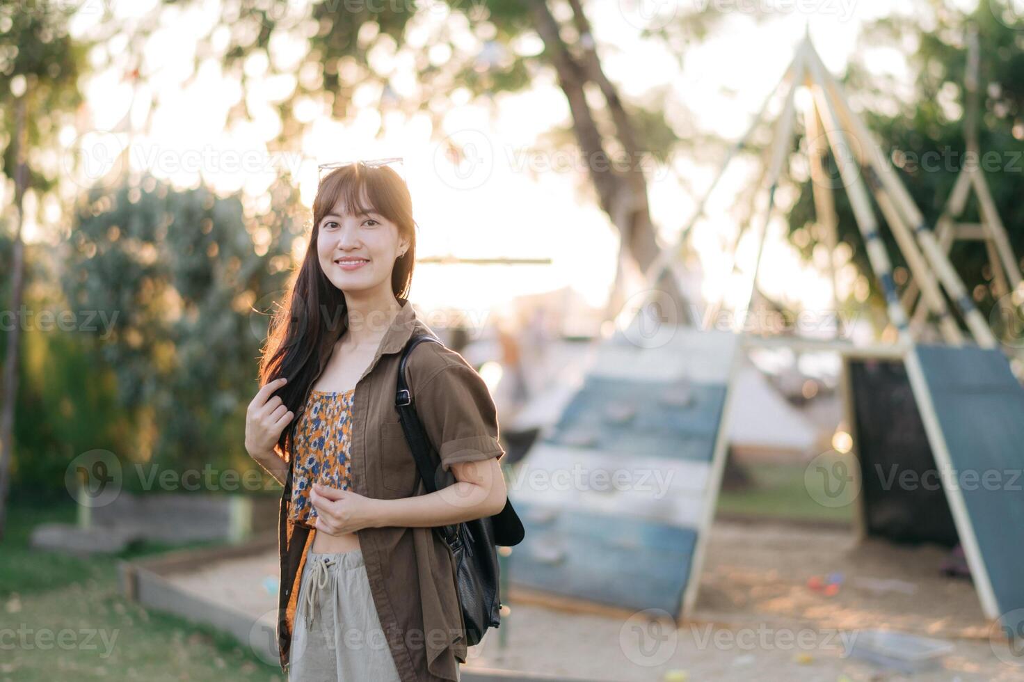 Asian woman in park with backpack photo