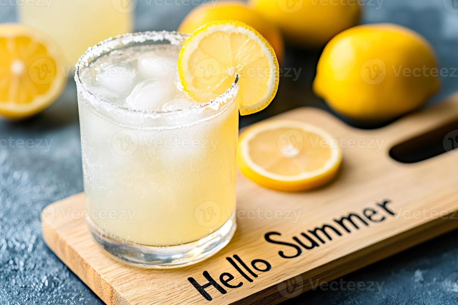 Refreshing lemonade with ice and lemon slice on wooden board saying hello summer photo