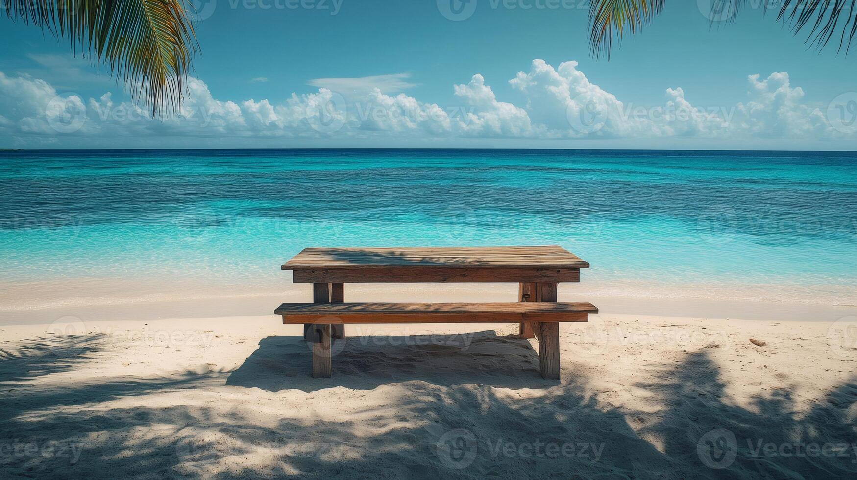 Wooden picnic table on a beautiful tropical beach with turquoise water photo