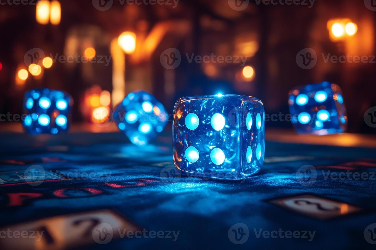 Glowing blue dice resting on casino table at night photo