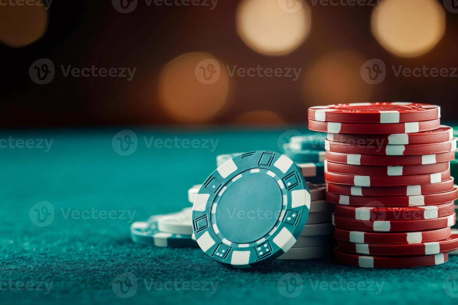 Poker chips stacked on green felt table illuminating casino atmosphere.. photo