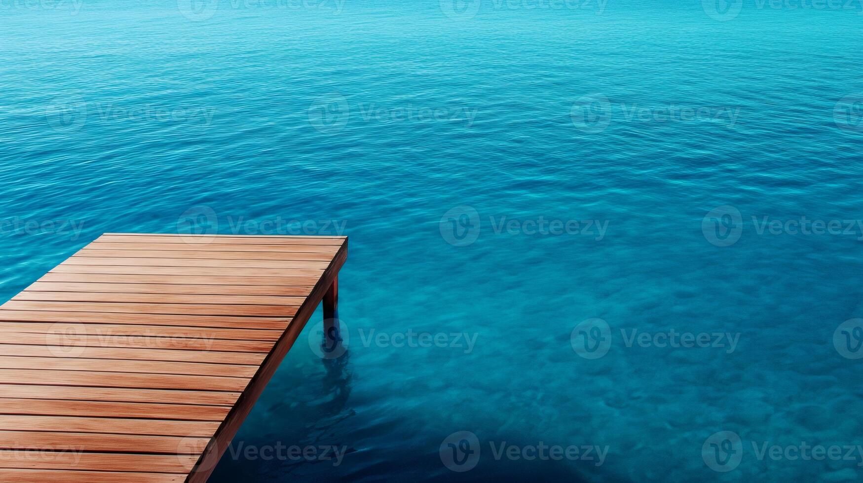 Wooden pier extending into tranquil turquoise water photo
