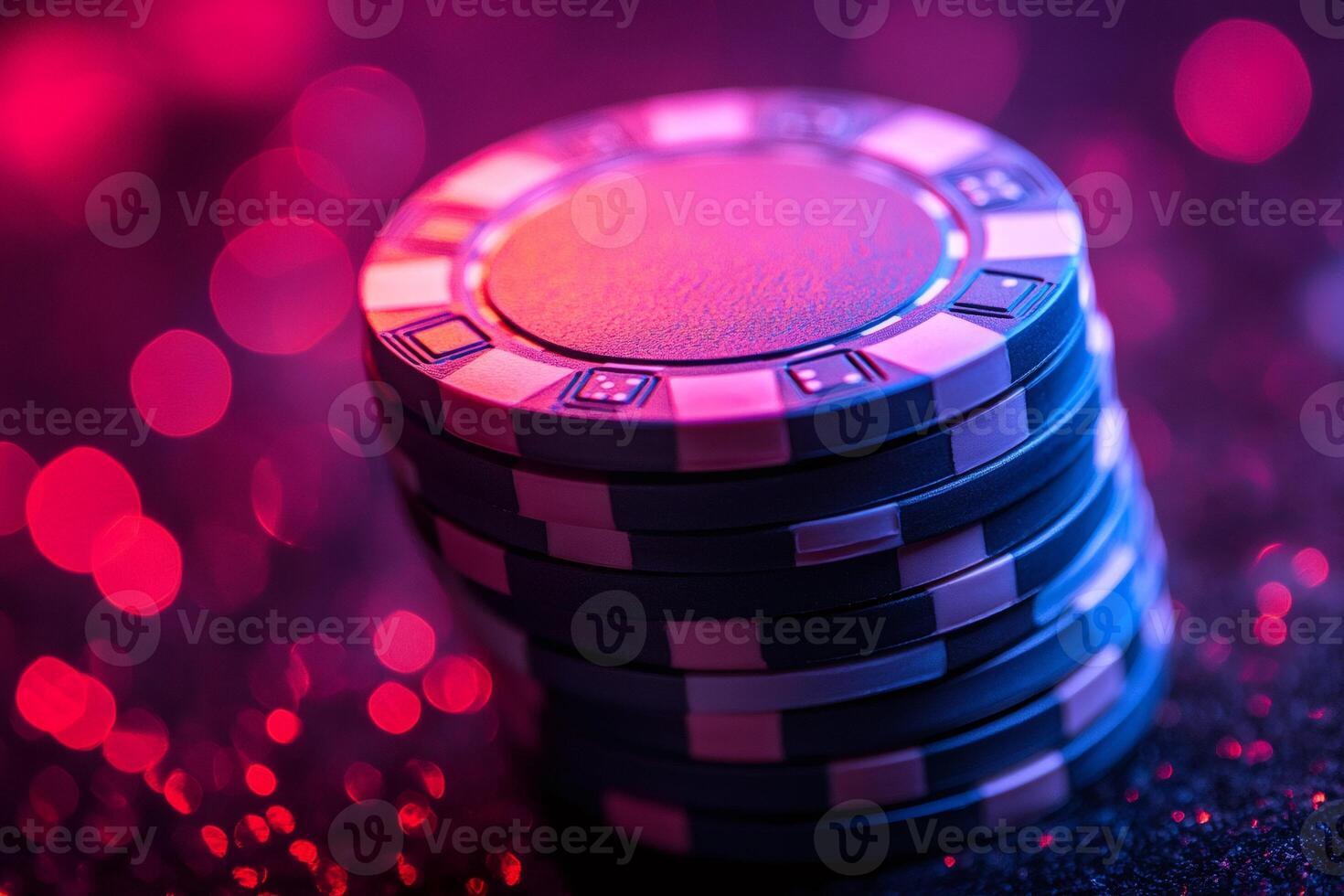 Stack of poker chips illuminated by pink and blue neon lights photo