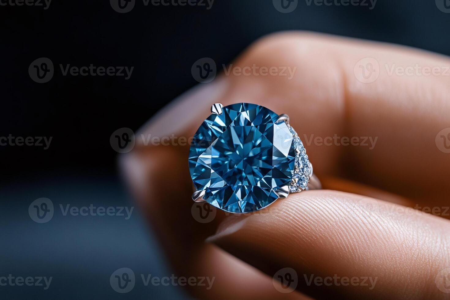 Jeweler holding a big blue diamond ring photo