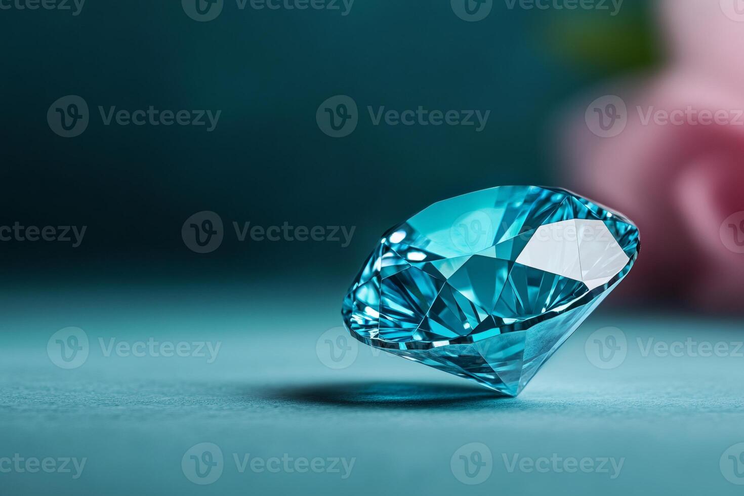 Large sparkling light blue diamond resting on teal surface photo