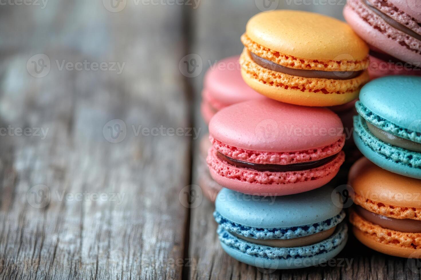 Macarons forming a small pyramid on a rustic wooden table photo