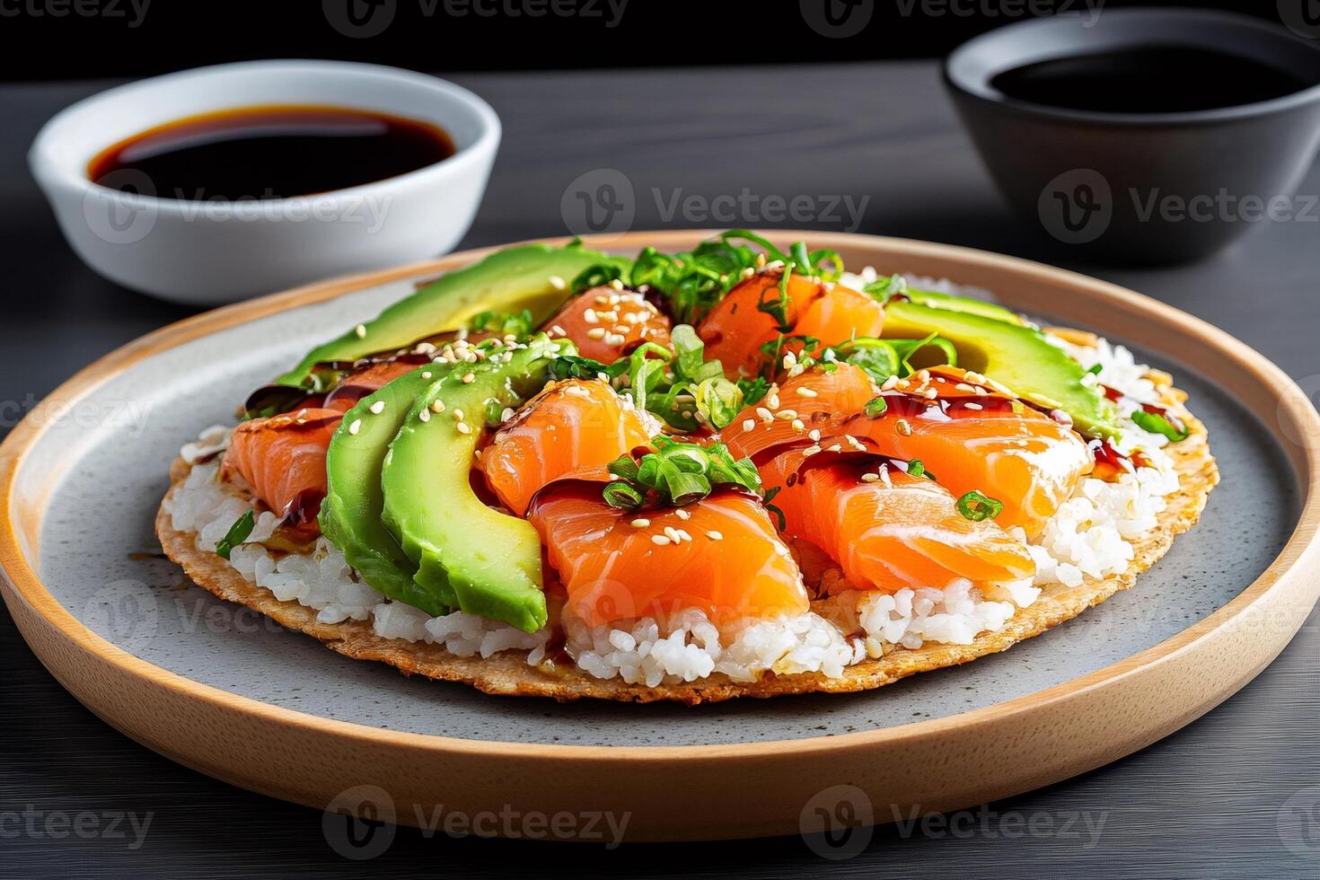 Sushi pizza with salmon, avocado and sesame seeds is ready to eat photo