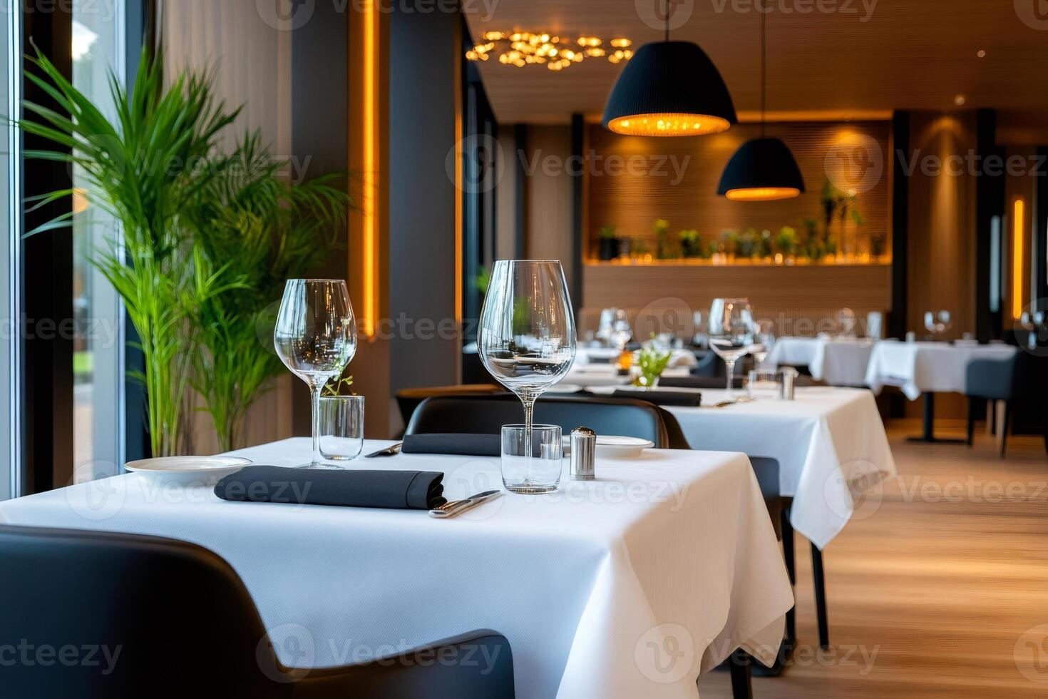 Elegant restaurant interior design with table setting and wine glasses photo