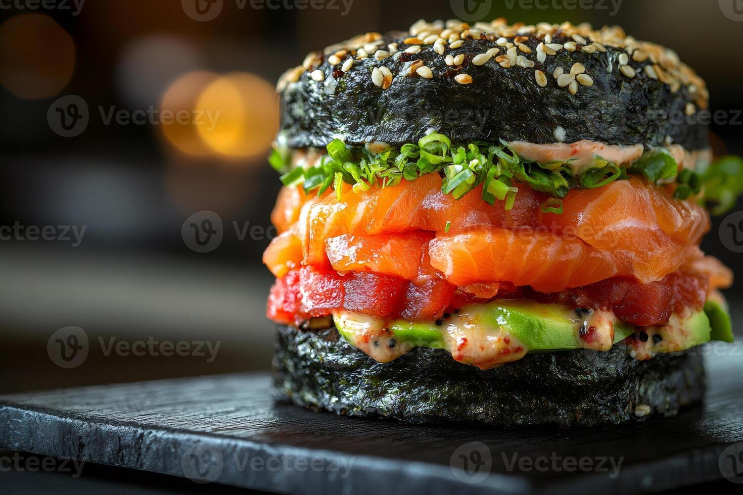 Delicious sushi burger with salmon, tuna, avocado and sesame seeds layered on crispy nori bun photo