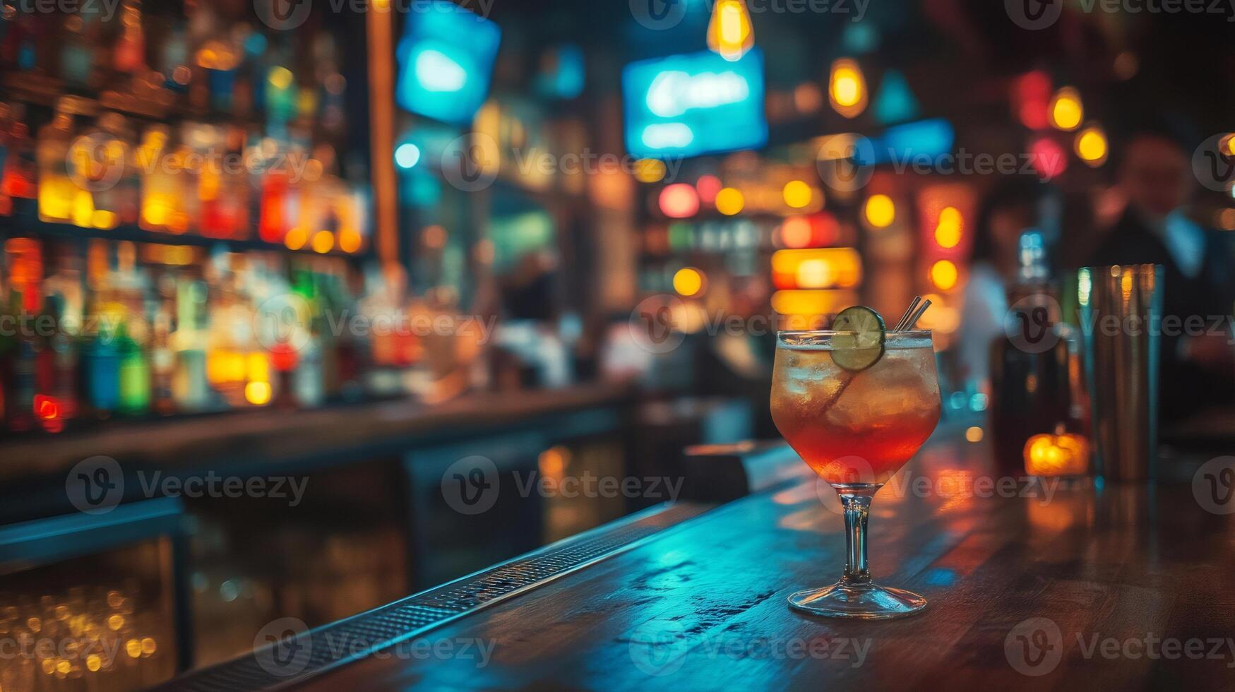 Refreshing cocktail stands on bar counter in blurred pub background photo