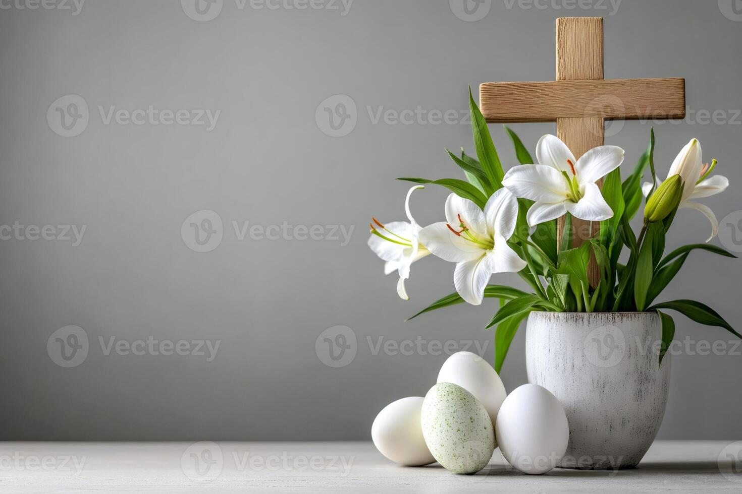 Easter eggs and white lilies with wooden cross symbolizing resurrection of jesus christ photo
