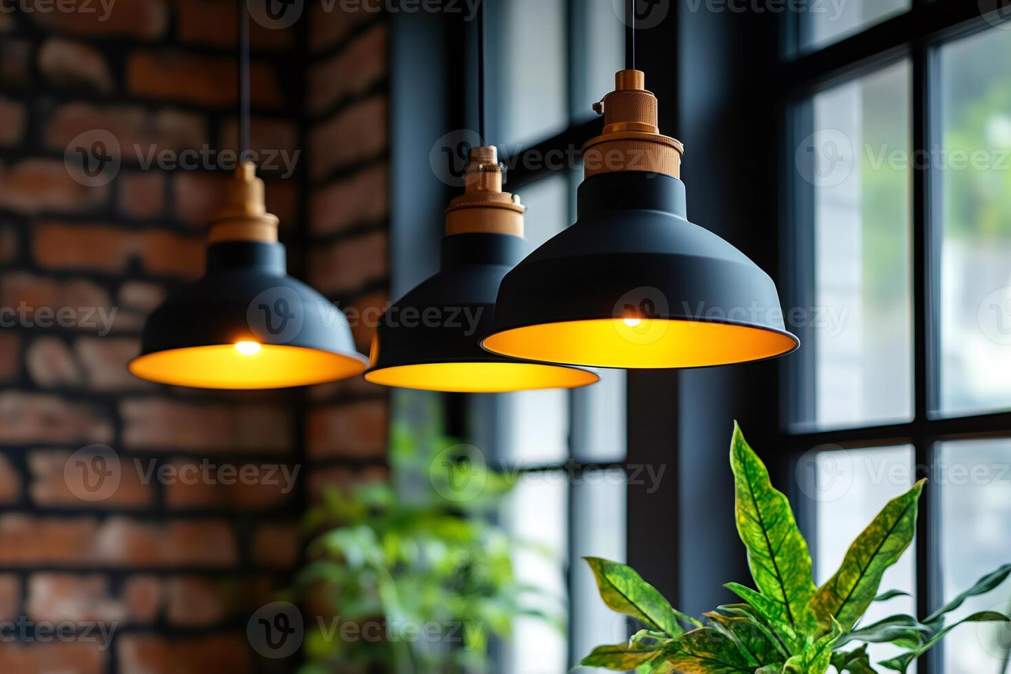 Three hanging black lamps illuminating a brick wall and window photo