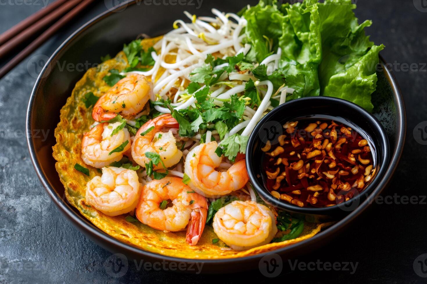 Delicious savory vietnamese crepe with shrimp and bean sprouts filling and dipping sauce photo