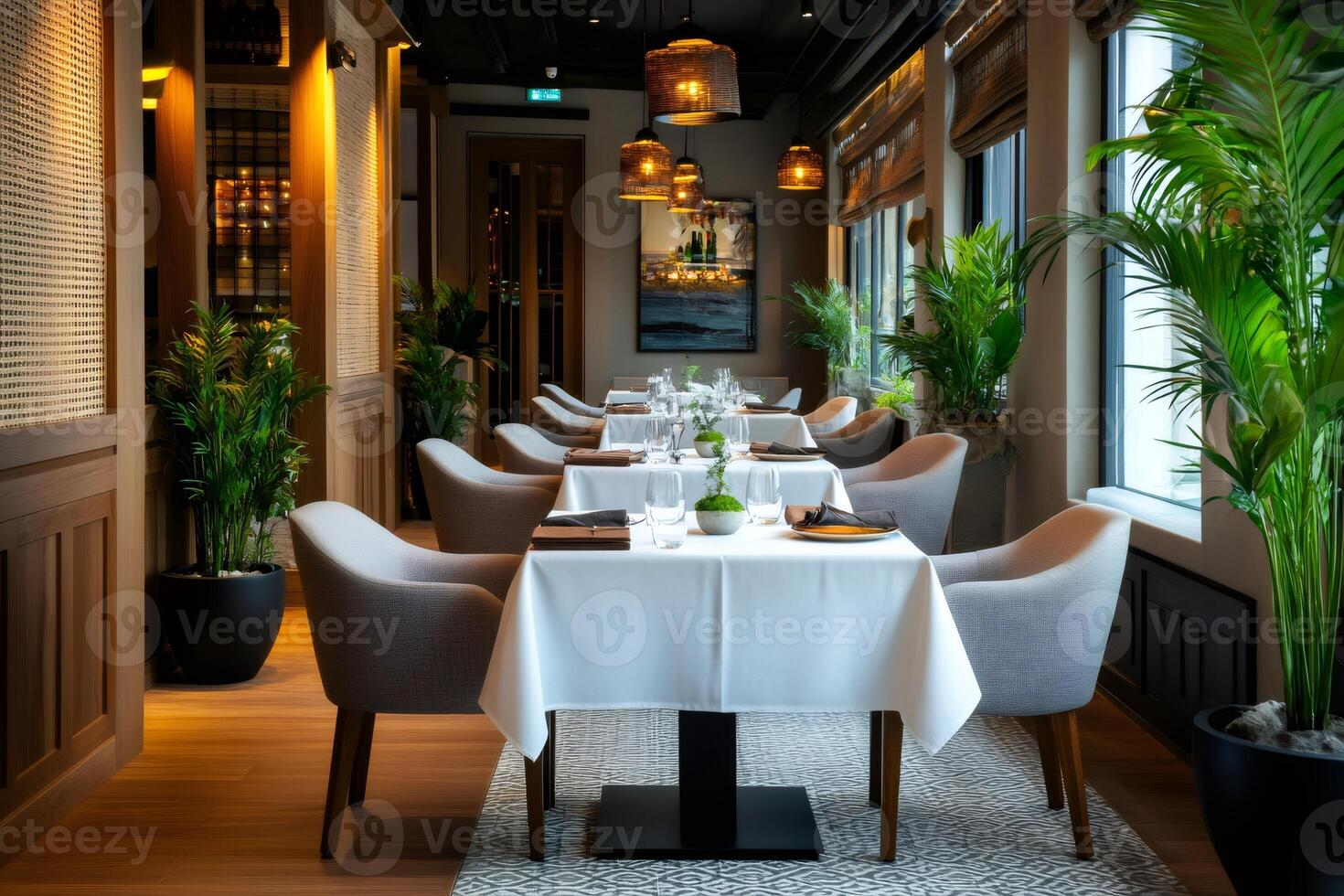 Elegant restaurant interior design with table setting and potted plants photo