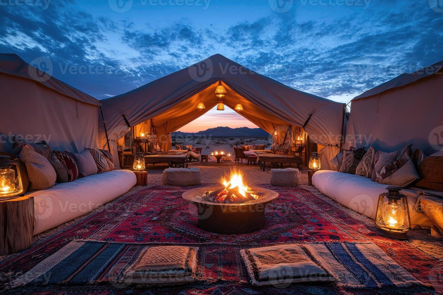Luxurious desert camping experience with bonfire and comfortable seating under canvas tent photo