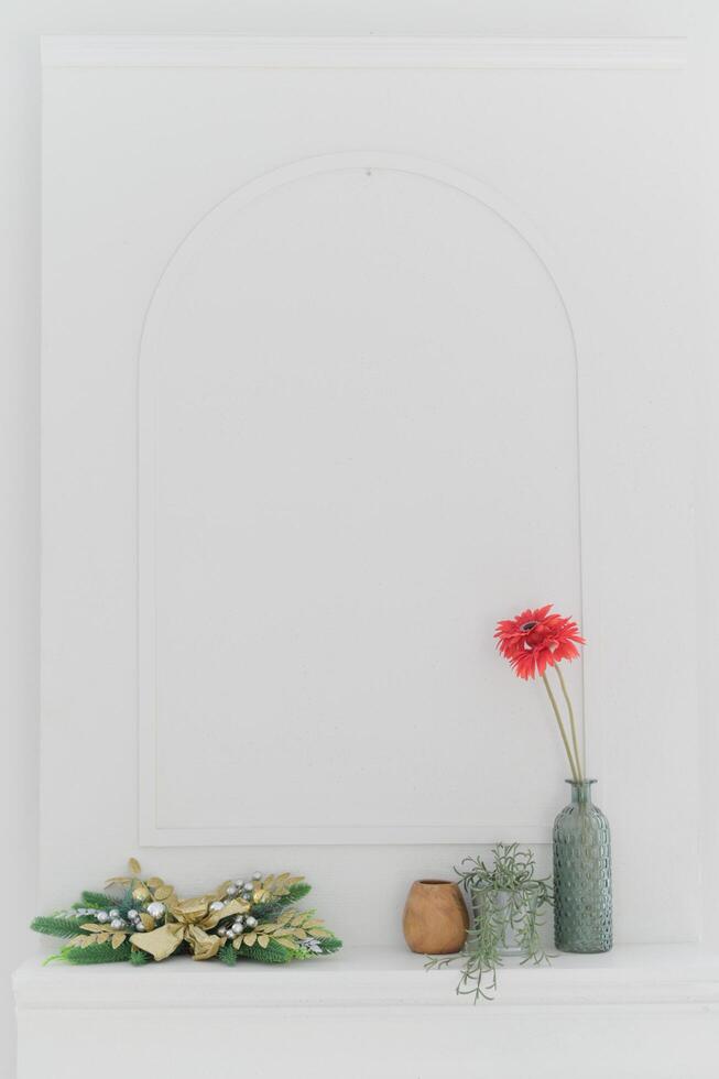 Minimalist decor with red flower in vase and greenery accents photo