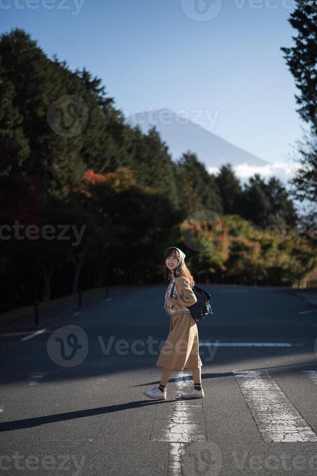 Tanuki Lake escape, Asian woman explores Tokyo in casual dress, enjoying a holiday filled with smiles, shopping, and the bustling energy of the urban community near Mount Fuji. photo