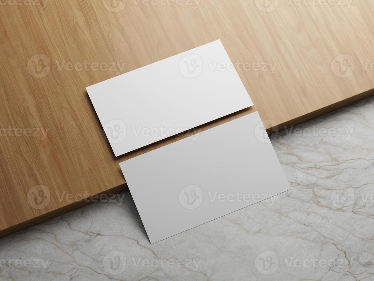 Two white business cards placed on a wooden table with marble background. photo