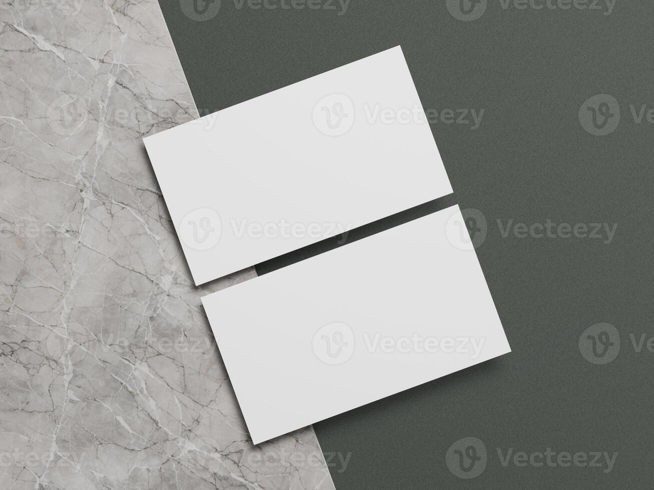 Elegant business card mockup with clean white cards positioned diagonally over a marble and dark green surface. photo