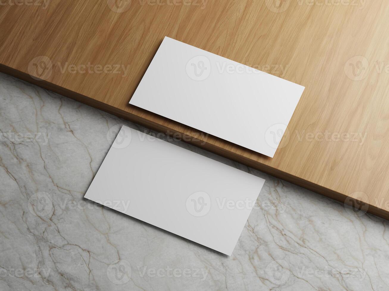 Two white business cards placed on a wooden surface with a marble backdrop. photo