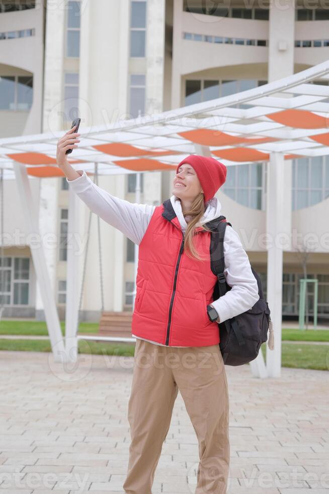 sportive woman taking selfie on the phone in the city street photo