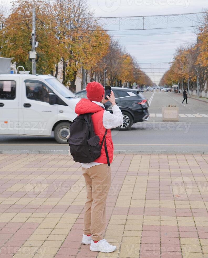 Caucasian woman texting using smartphone in the street outdoors photo