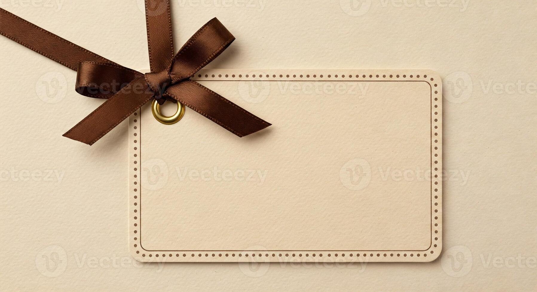 Blank card with brown ribbon and bow on beige background photo