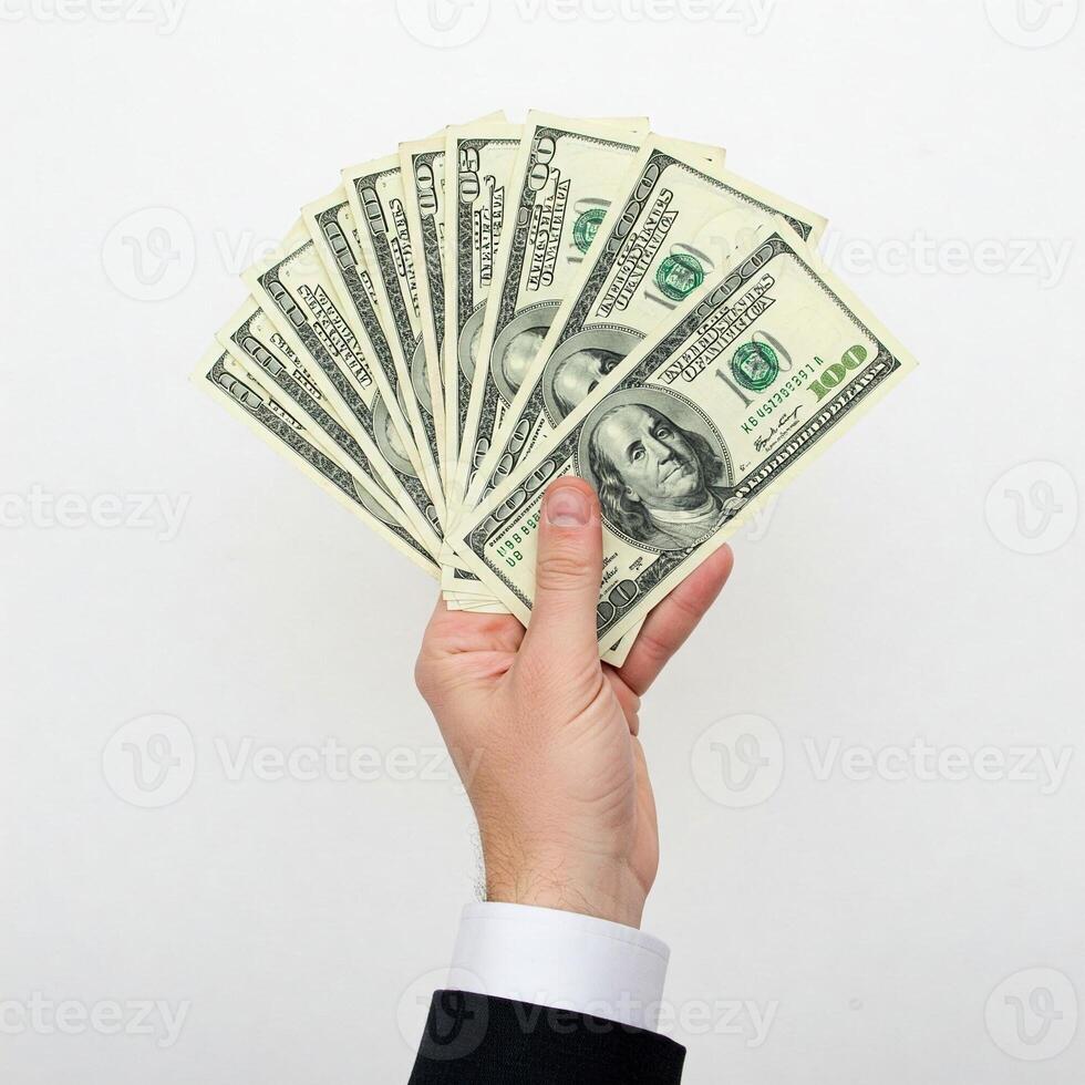 A man in a suit holding up a stack of money photo