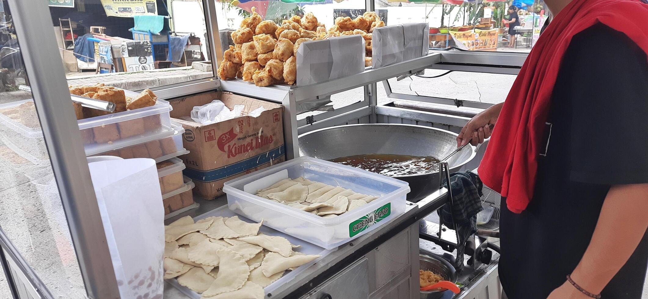 Fried tofu and cireng snack or gorengan at street food. Famous traditional fritters cheap, tastes savory and crispy food. Bekasi, West Java, Indonesia - March 19 2025 photo