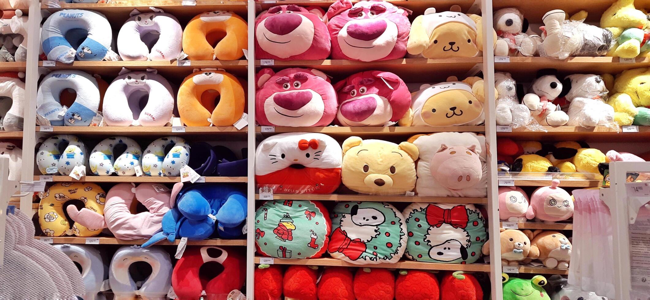 A cute and fluffy dolls display on the shelf in Miniso store for sale. Stuffed soft toys. Bekasi, West Java, Indonesia - February 28 2025 photo