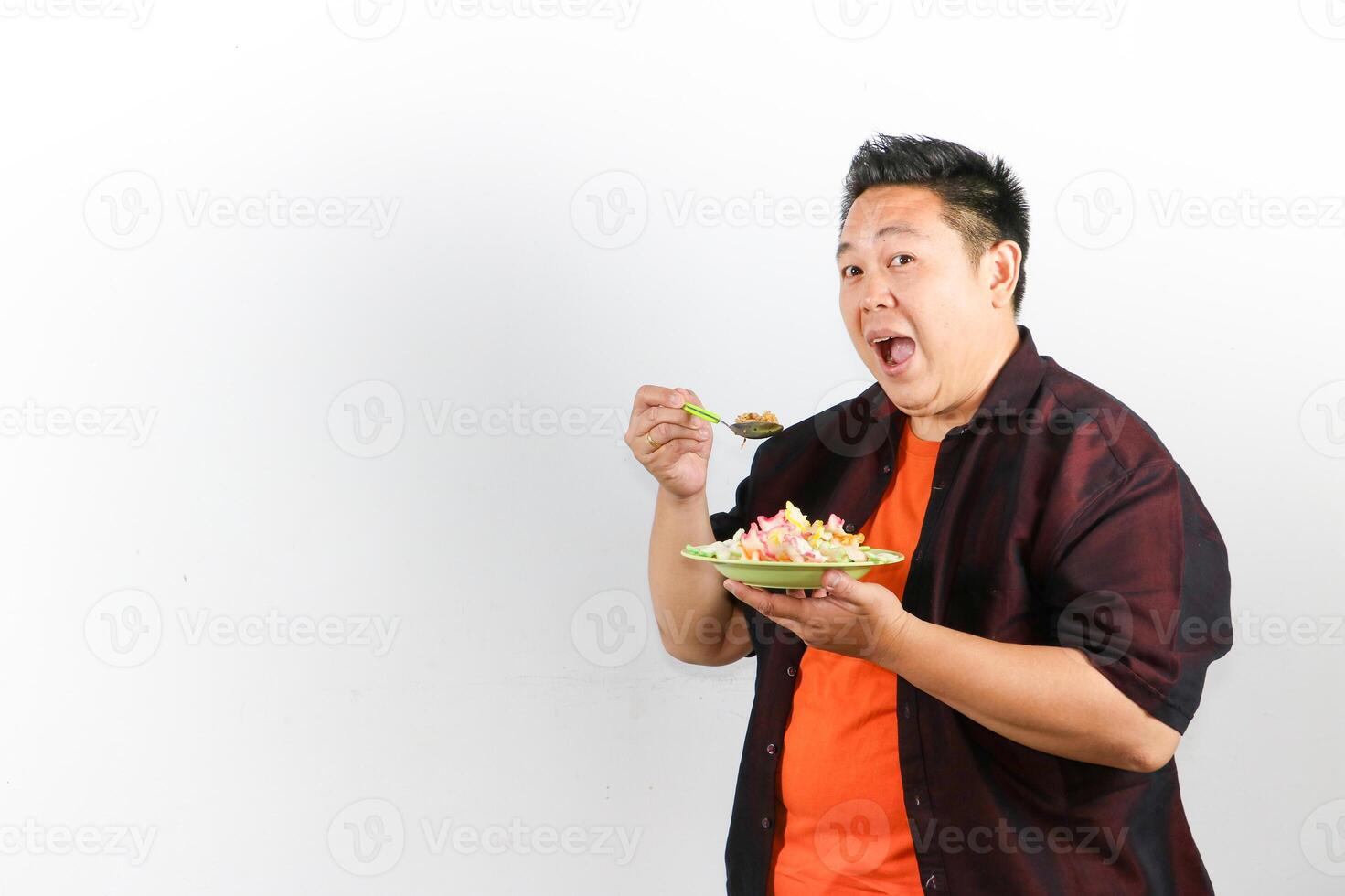 Asian man enjoying a delicious Indonesian Fried Rice with happy expression photo
