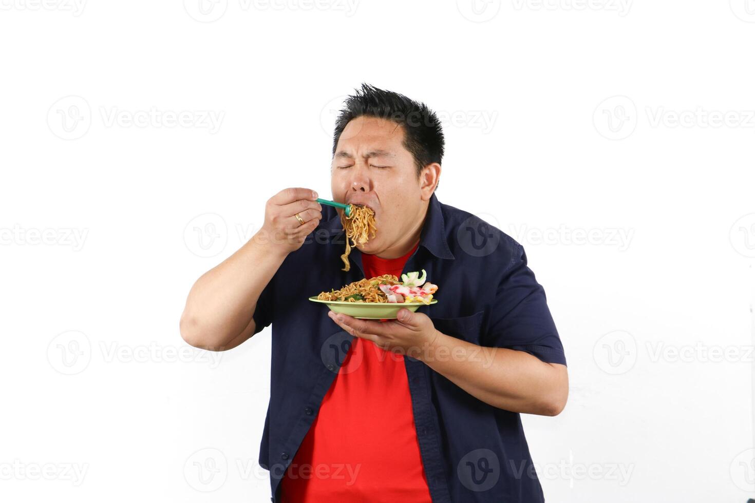 Man Enjoying a Delicious Indonesian Fried Noodles with excitement on his face photo