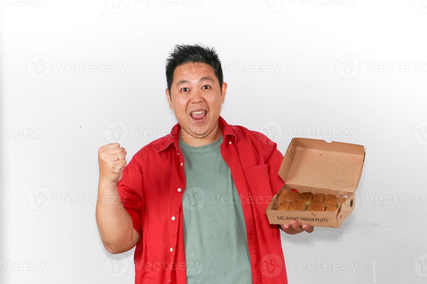 Happy man holding a box of Delicious Indonesian Martabak and making YES gesture photo