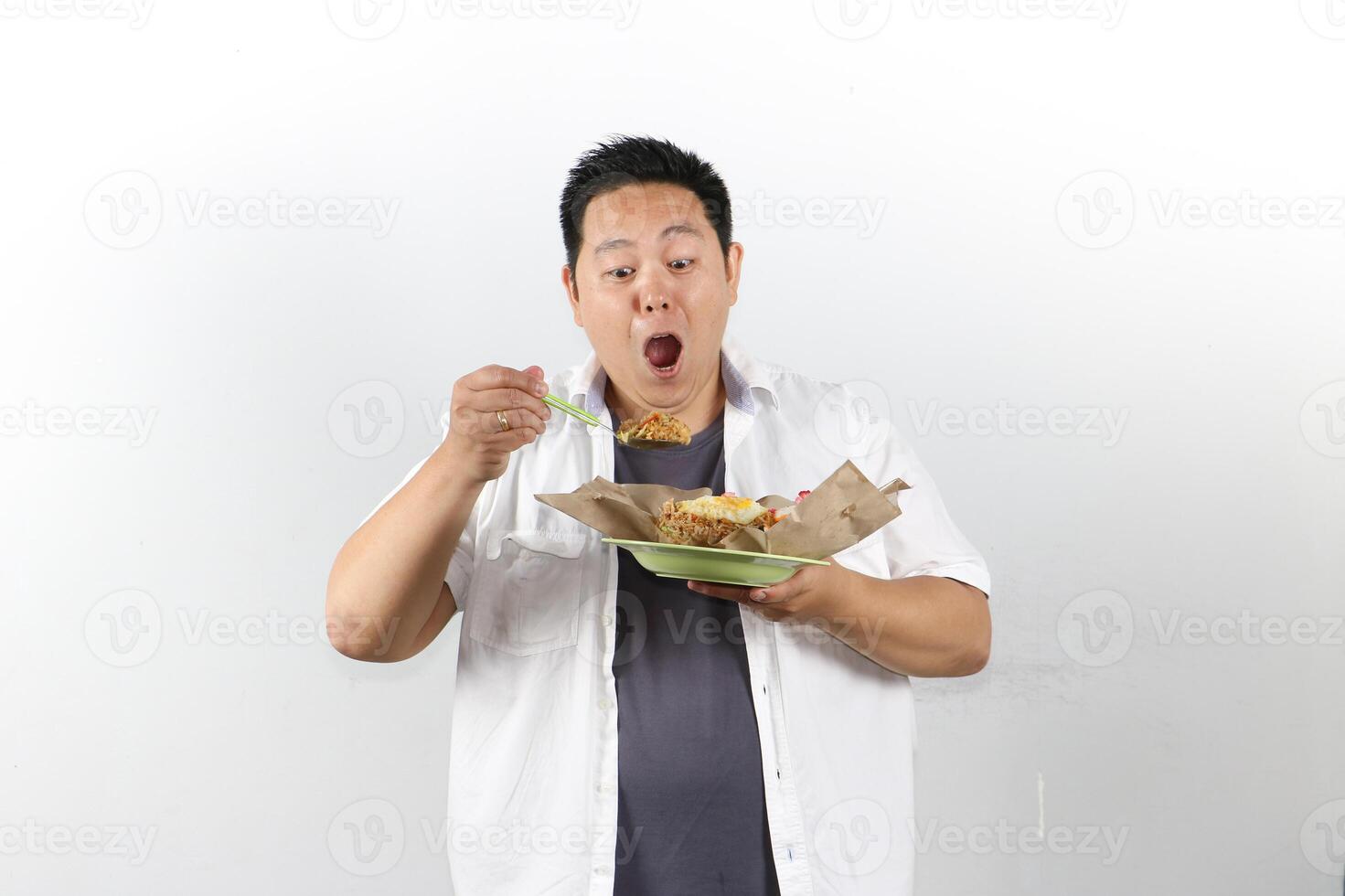 Man enjoying Indonesian Fried Rice with satisfied expression photo