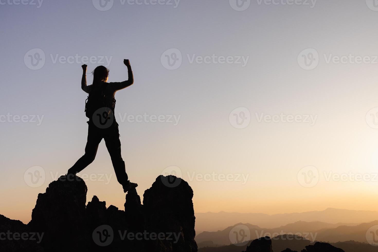 Silhouette of A person standing on top of the mountain Travel and adventure. Mountain hiking. Success. photo