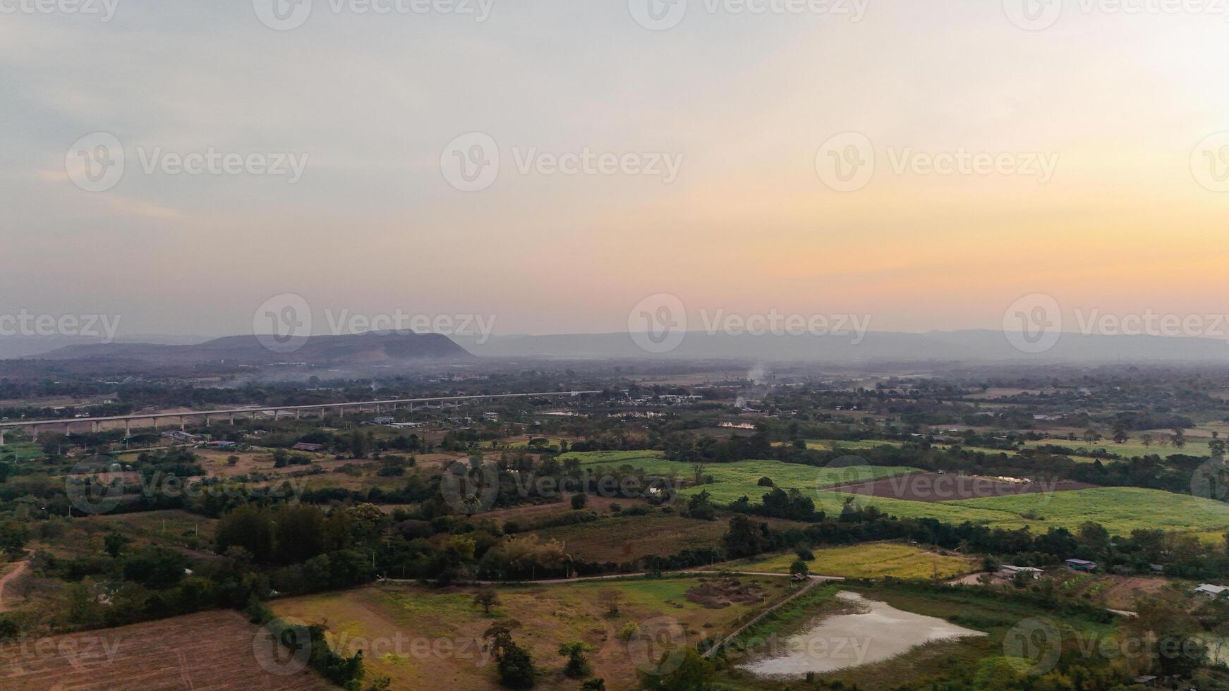 An aerial view of a valley and fields at sunset photo