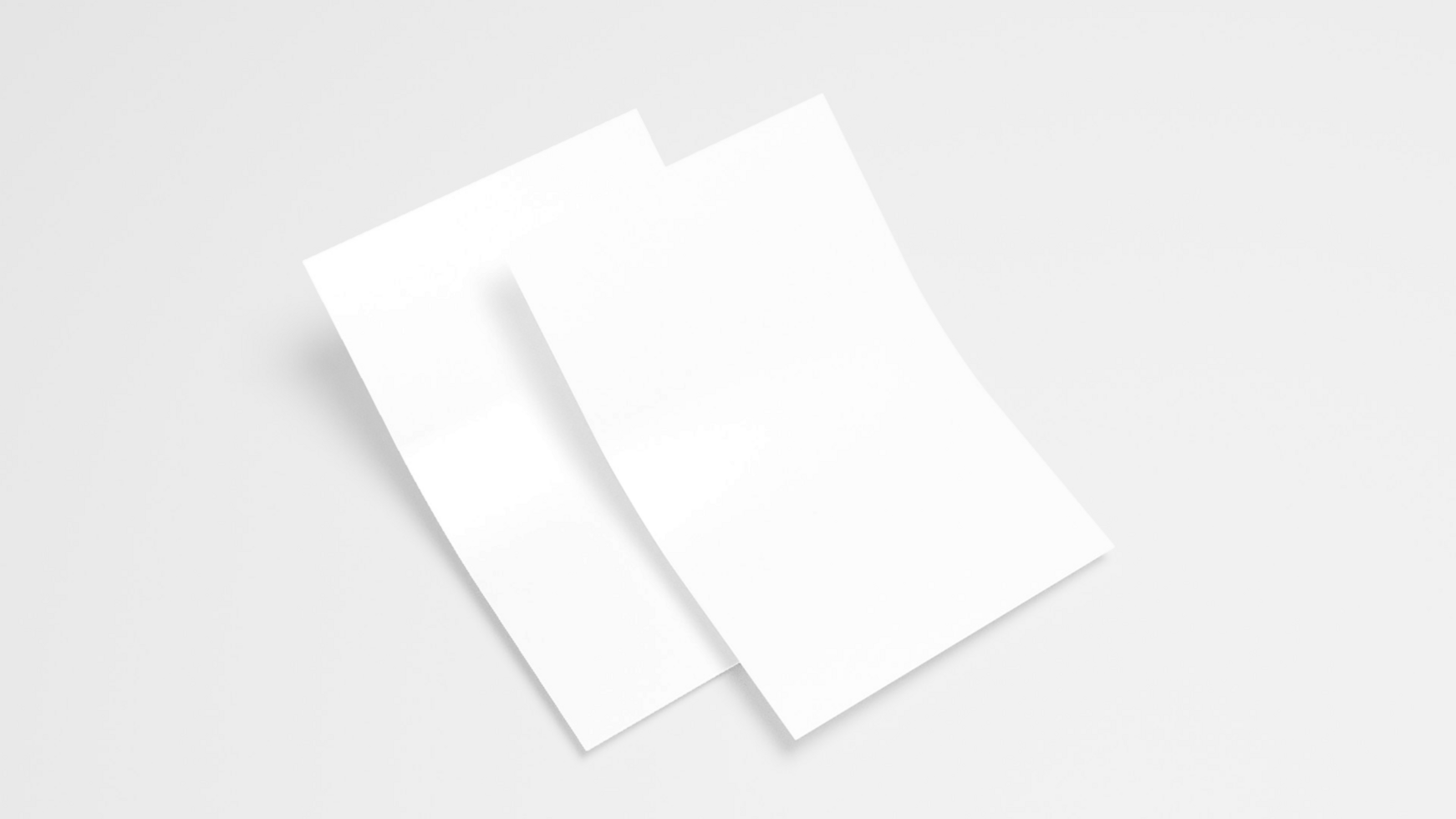 Two white sheets of paper on a white surface psd