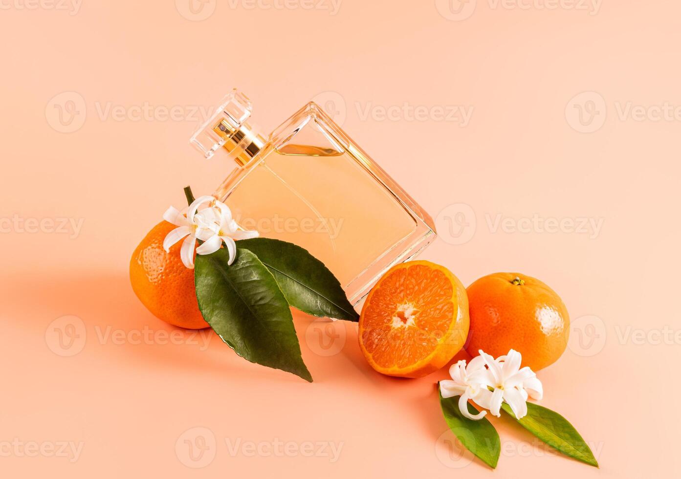 A transparent bottle of cosmetic spray, cologne, citrus-scented product lies on juicy tangerine fruits. product advertising. A blank bottle mockup. photo