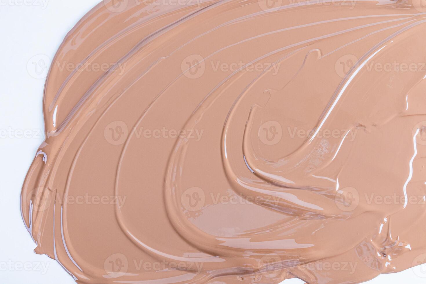 Liquid cosmetic texture of foundation, liquid powder in beige tone. waves of cosmetic texture. Abstract cosmetic background for product advertising. photo