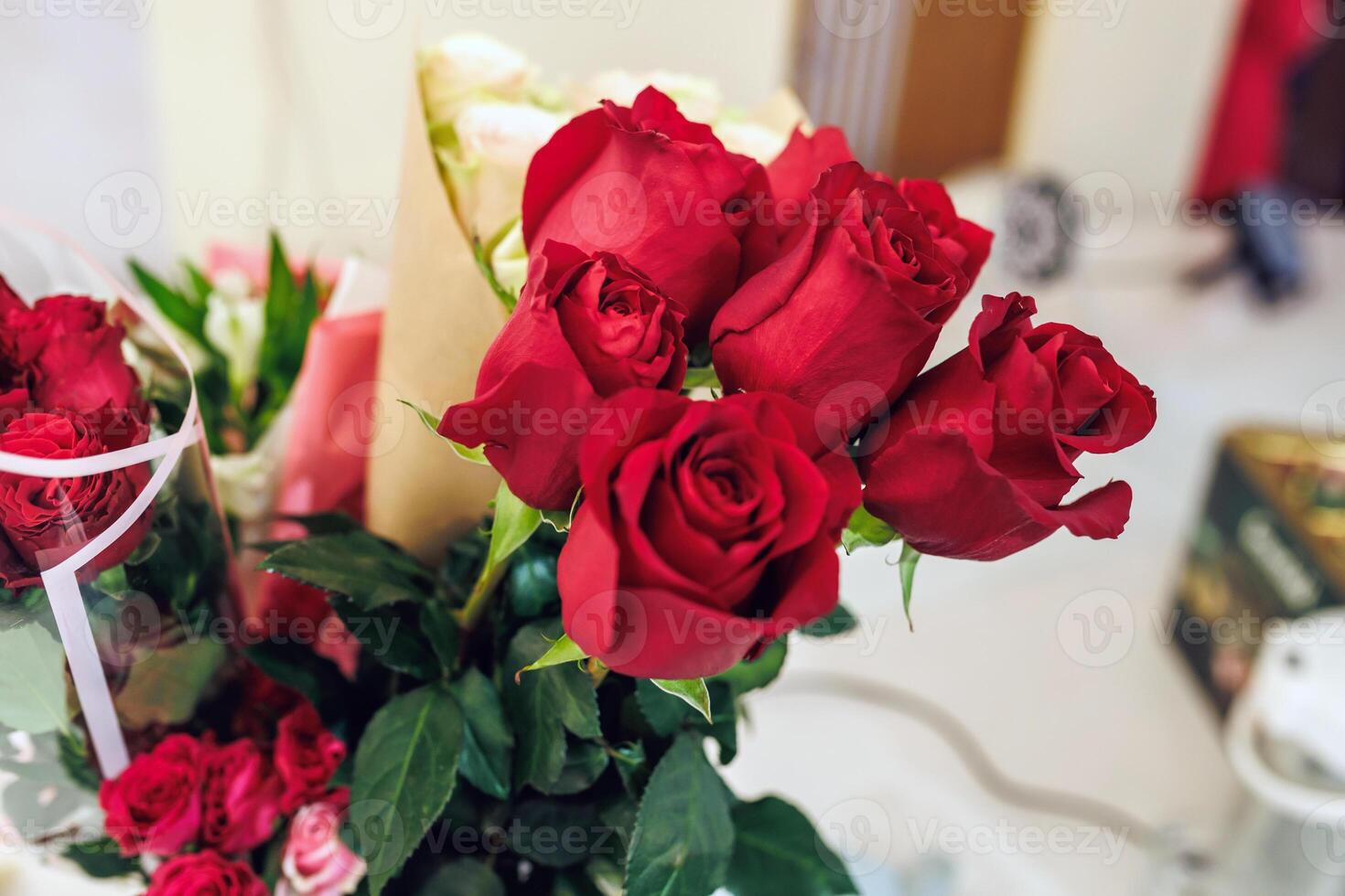 A bouquet of red roses sitting on a table photo