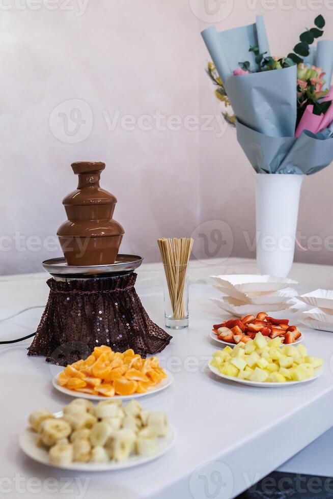 A table with plates of fruit and chocolate photo