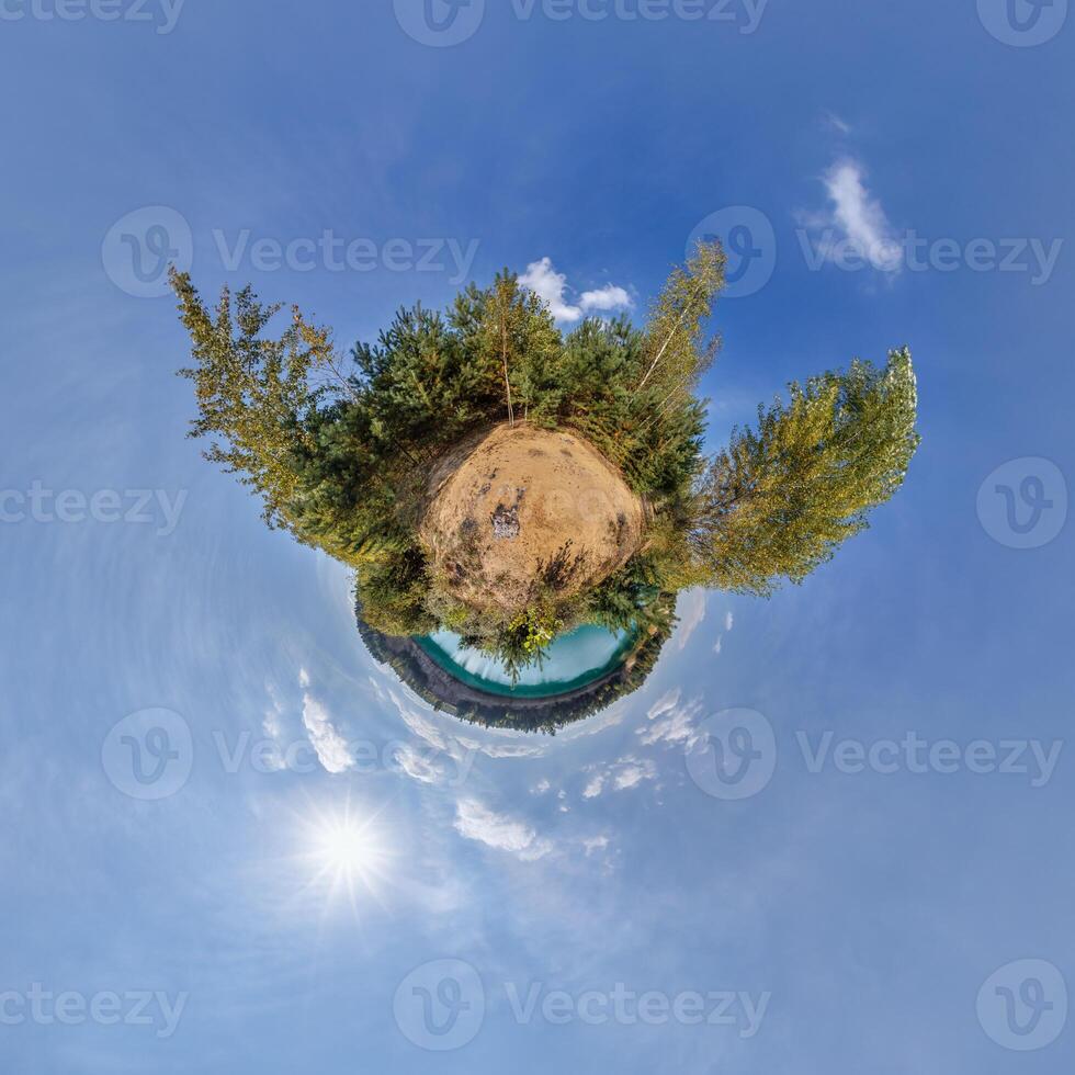 A small planet with trees and a blue sky photo