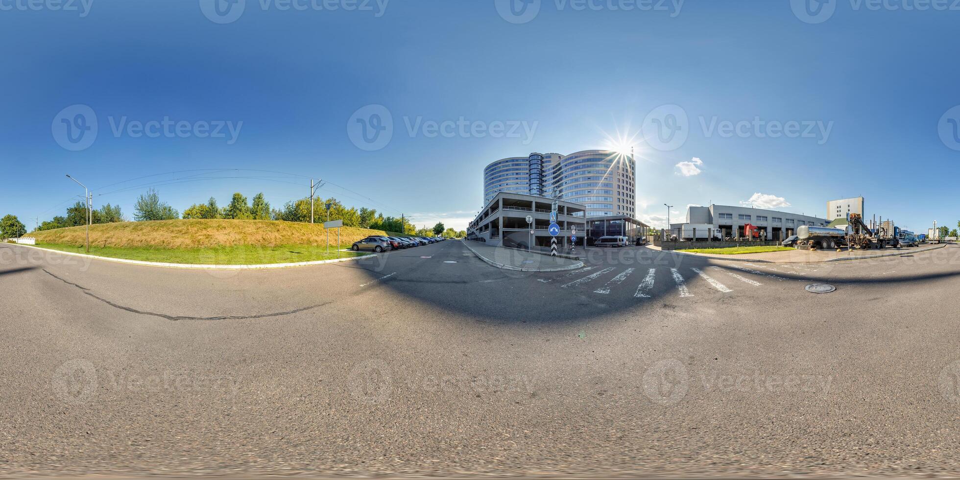 hdri 360 panorama on road near modern business office building with multi-level parking in equirectangular seamless spherical projection. VR content photo