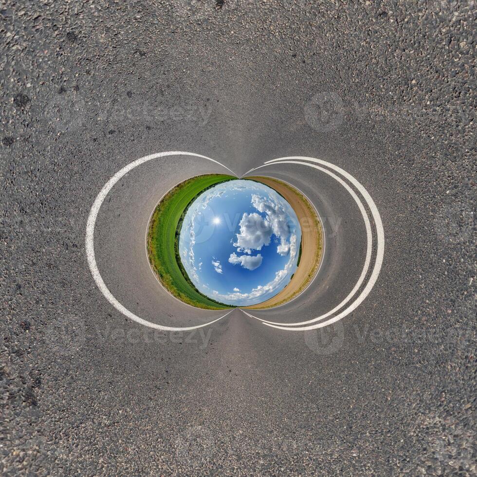 A circular road with a blue sky and white clouds photo