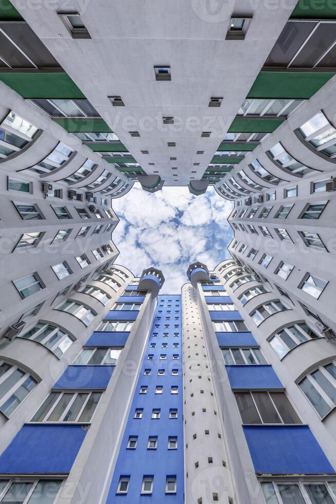 A view up at a building with blue and white windows photo